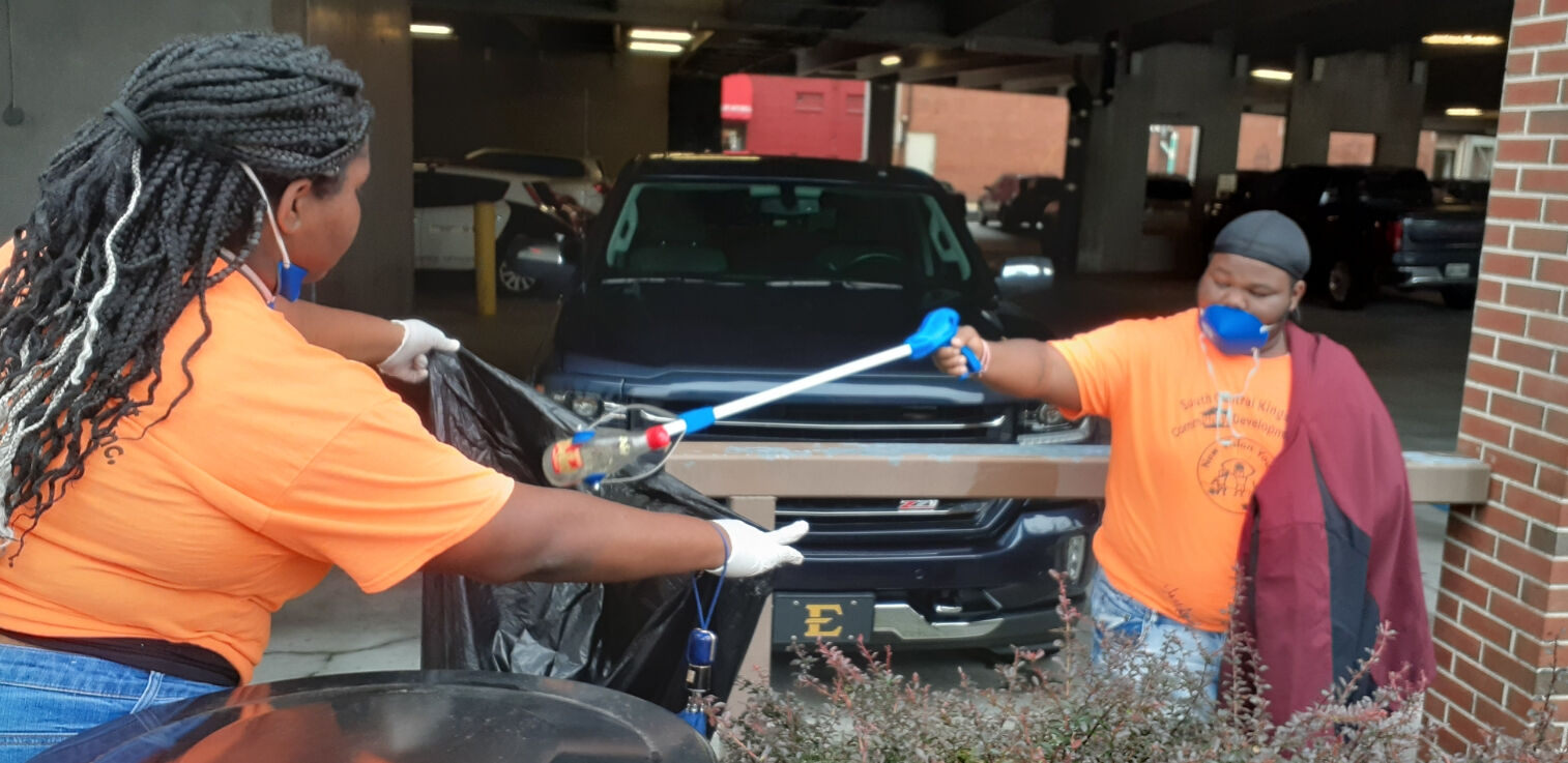 New Vision volunteers help with downtown cleanup